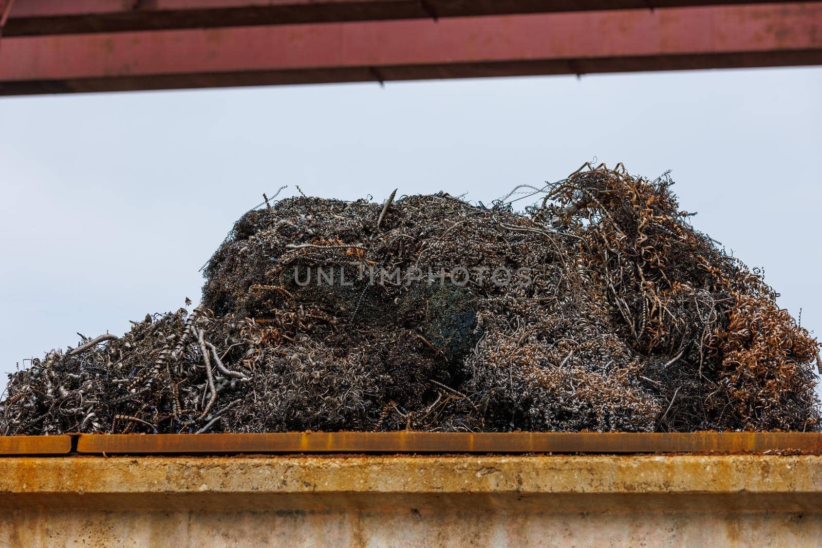 pile of metal swarf on blue sky background, close-up.