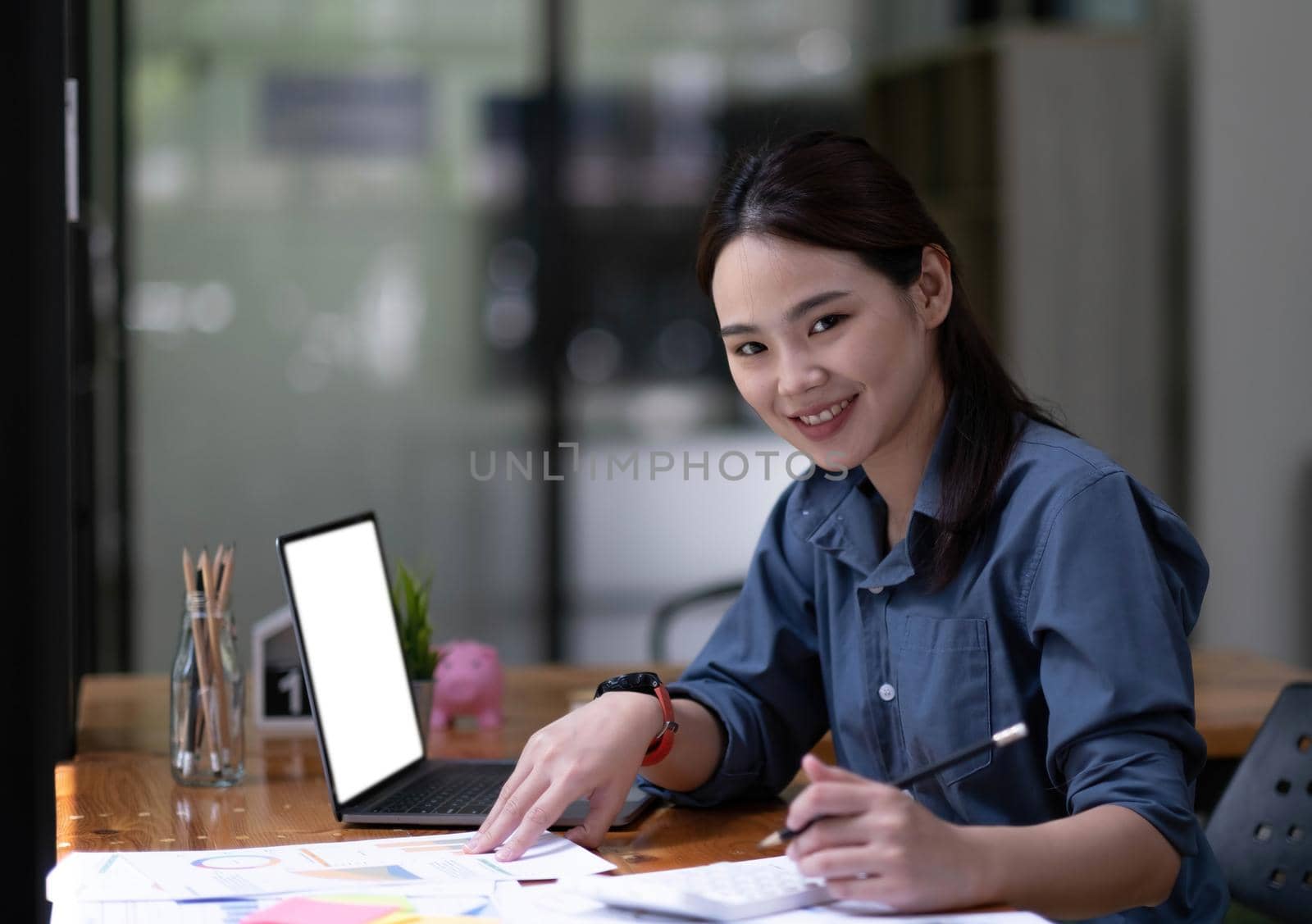 Shot of a asian young business Female working on laptop computer in her workstation.Portrait of Business people employee freelance online marketing e-commerce telemarketing concept..