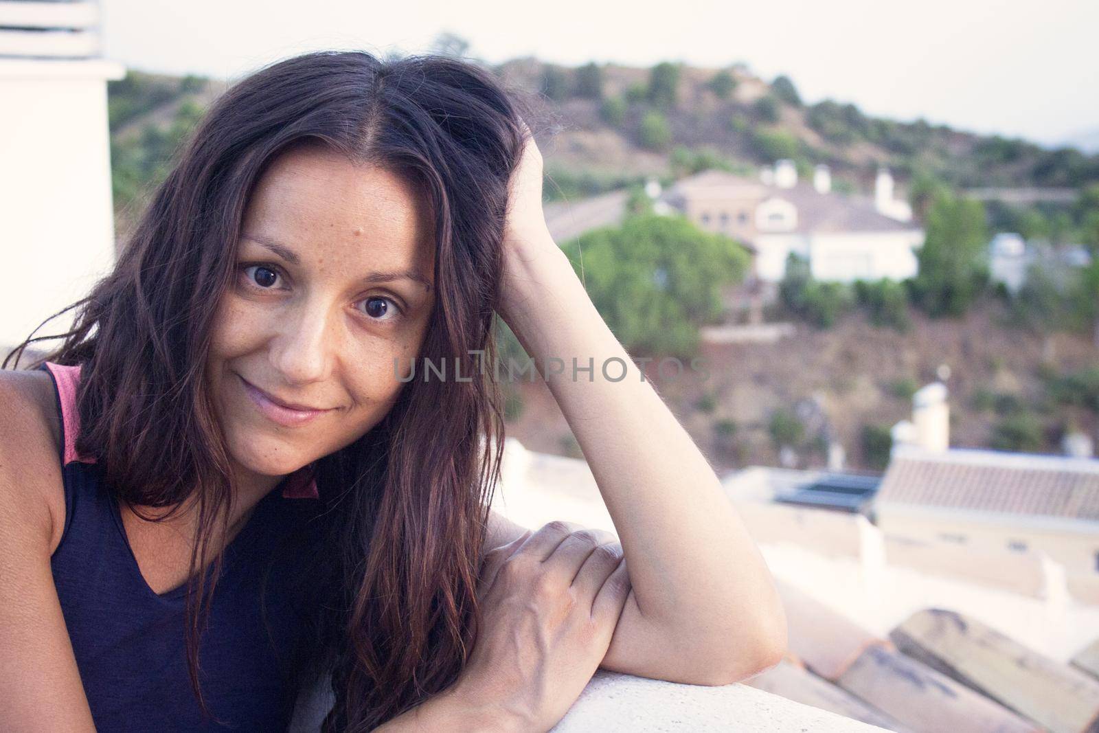 Portrait of youthful woman on mountain background. Smiling.