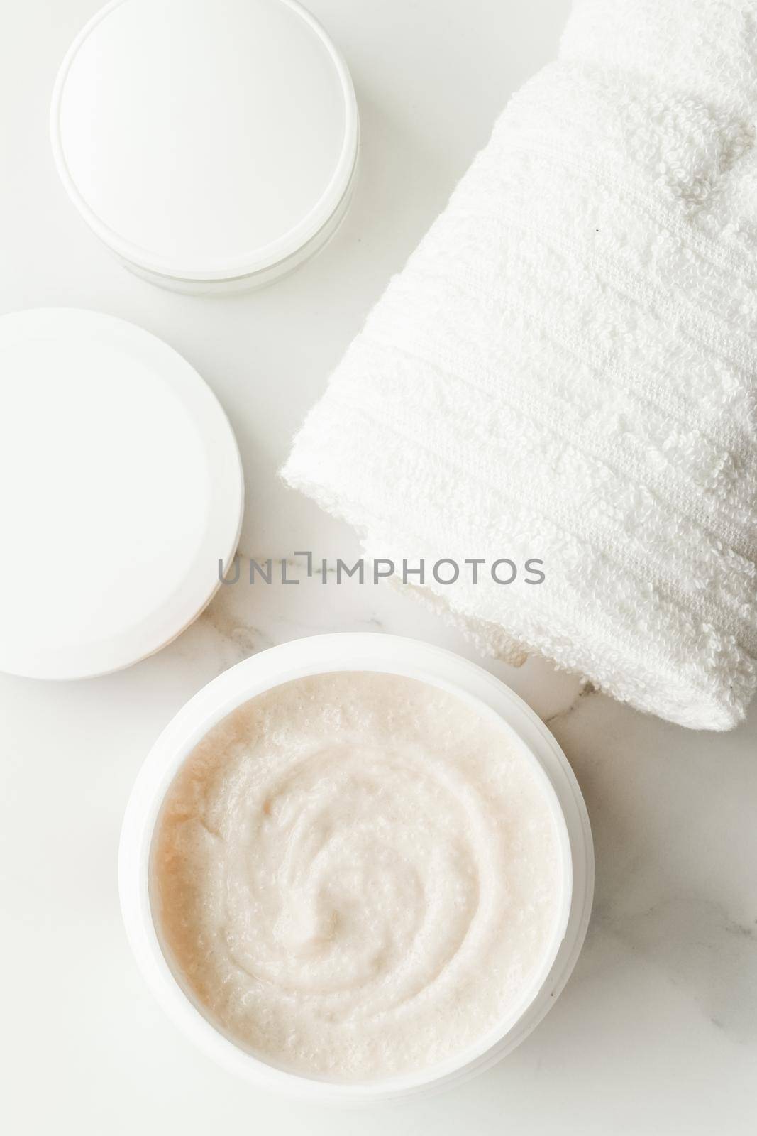 Scrub and exfoliating cream products on a marble, flatlay - skincare and body care, luxury spa and clean cosmetic concept. Health and beauty of your skin