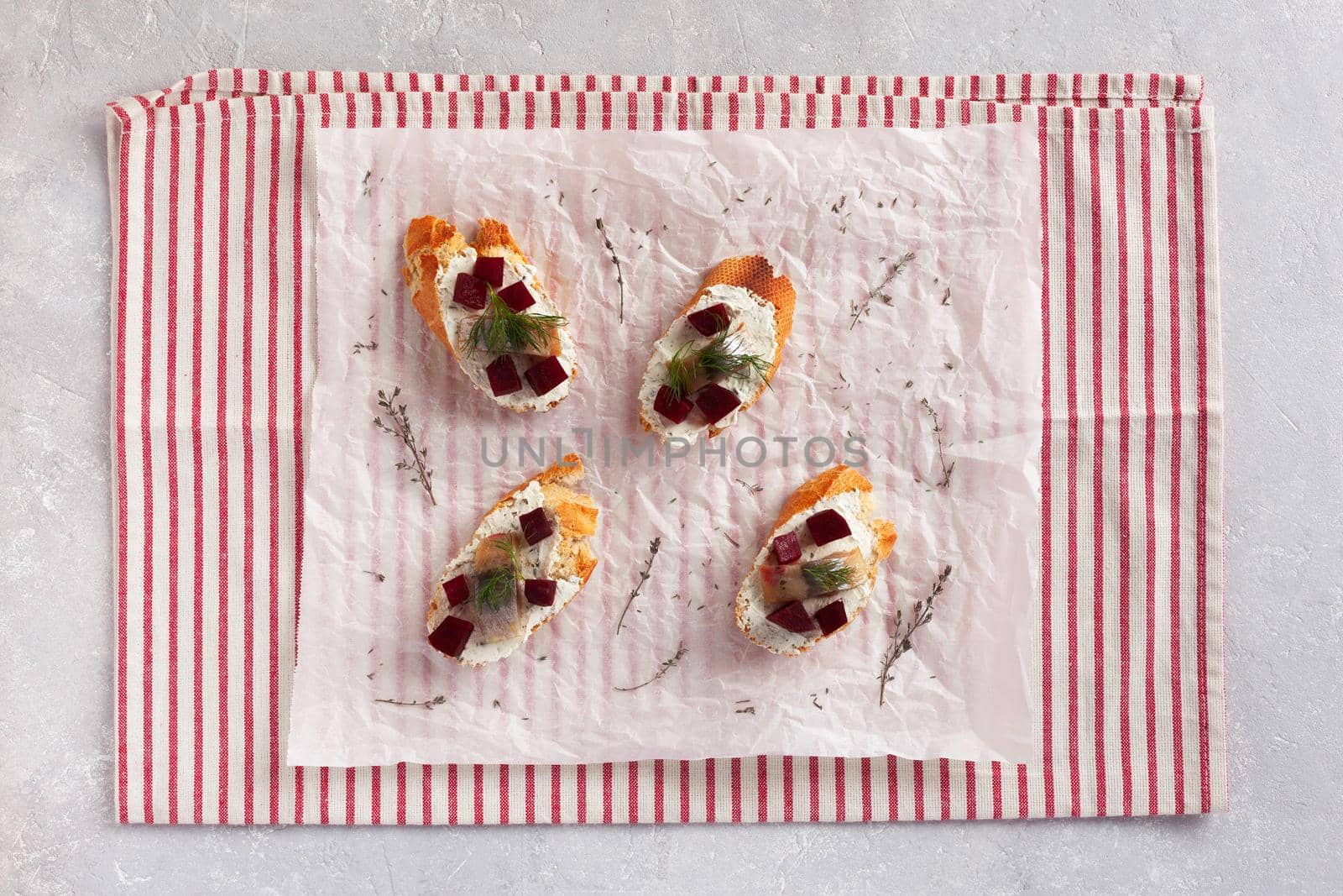 smoked hering, beet root and soft cheese toasts, top view