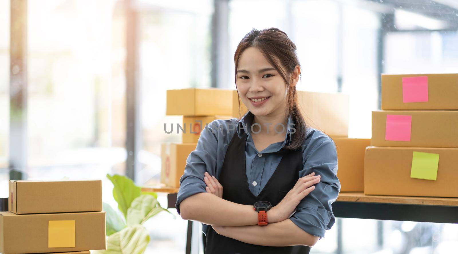 Portrait of Asian young woman SME working with a box at home the workplace.start-up small business owner, small business entrepreneur SME or freelance business online and delivery concept..