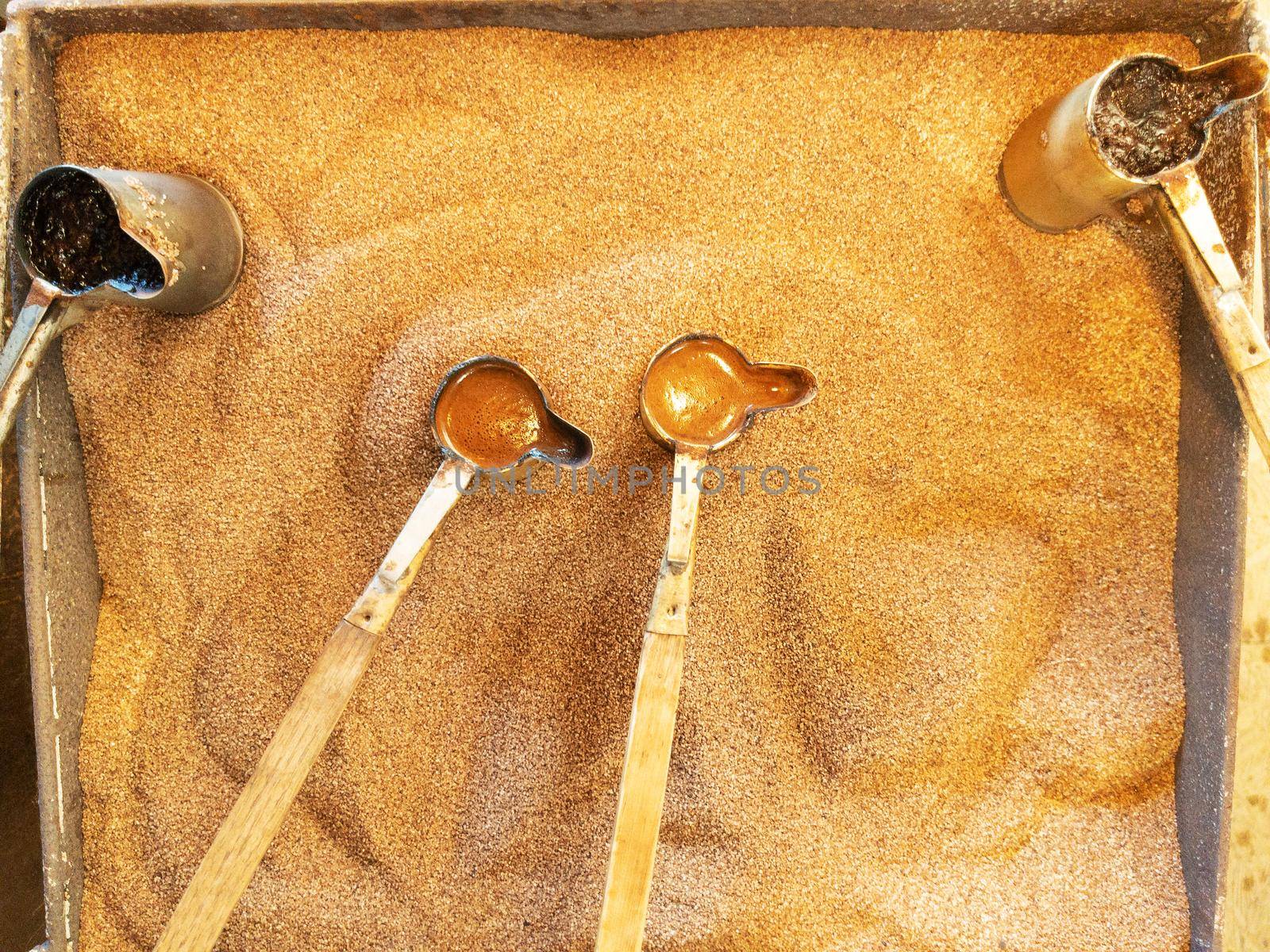 Preparation of natural coffee in Turks on the sand. Turkish coffee