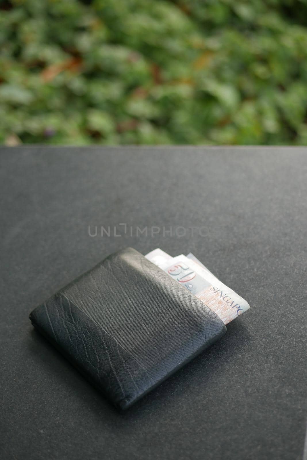 left wallet on a bench in the park ,