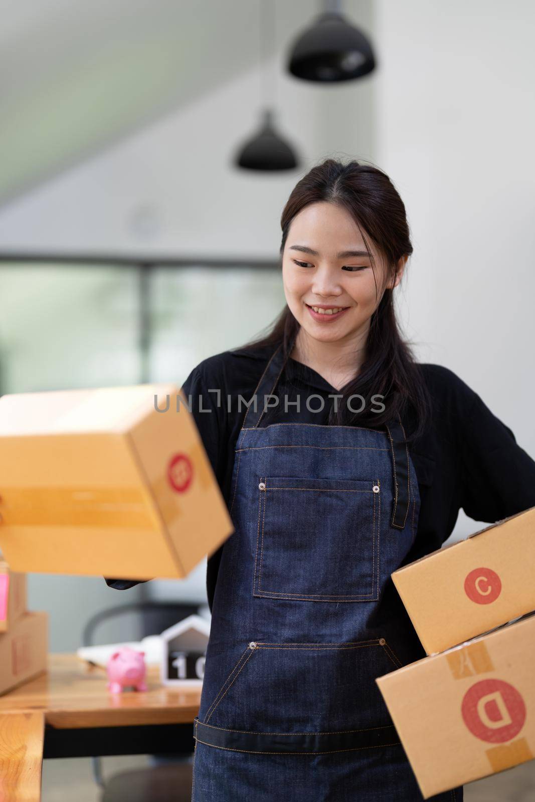 businesswoman start small business and successful SME entrepreneurs A woman works from home delivering parcels online. SME delivery concept and packaging.