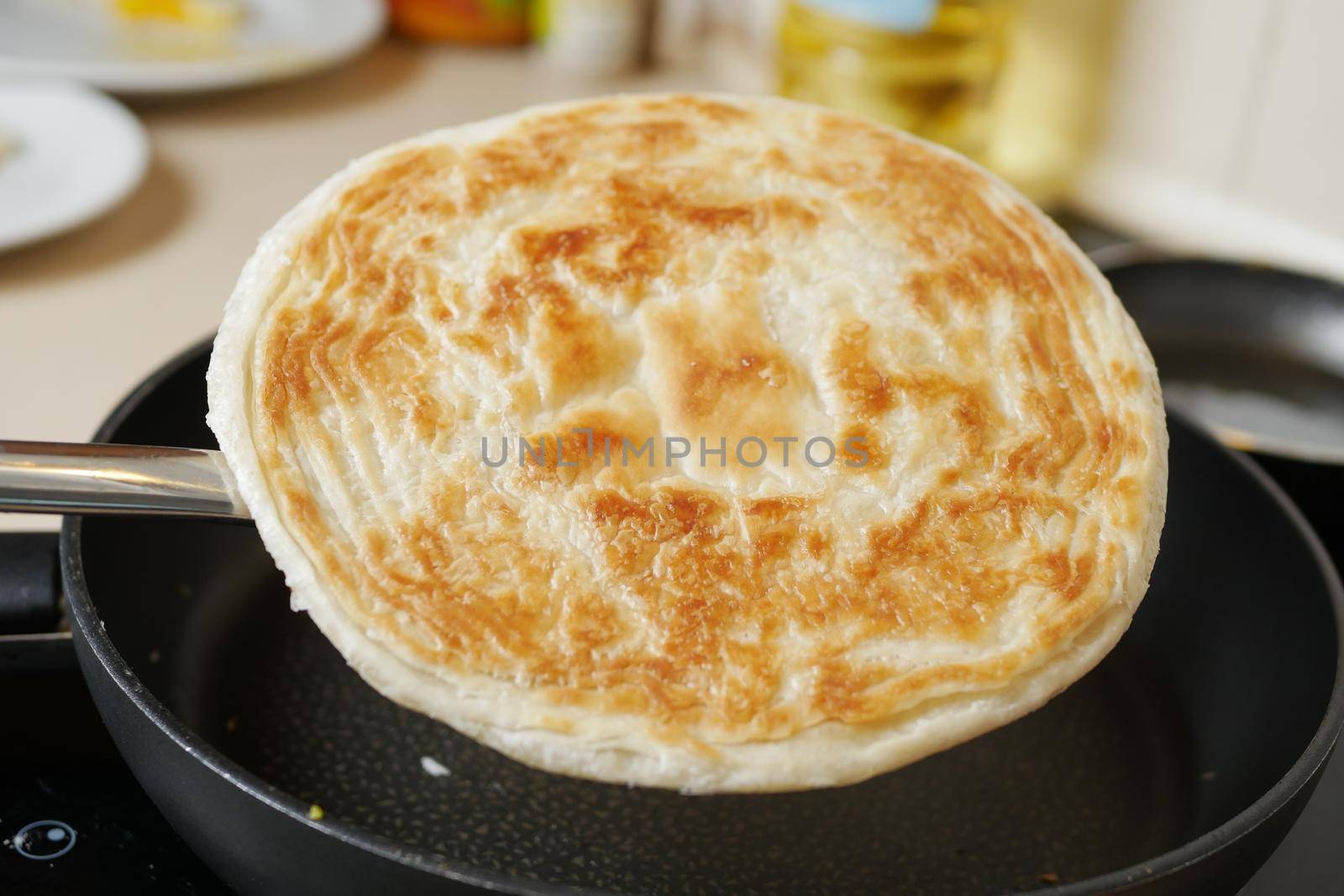 cooking roti chapati on a cooking pan ,