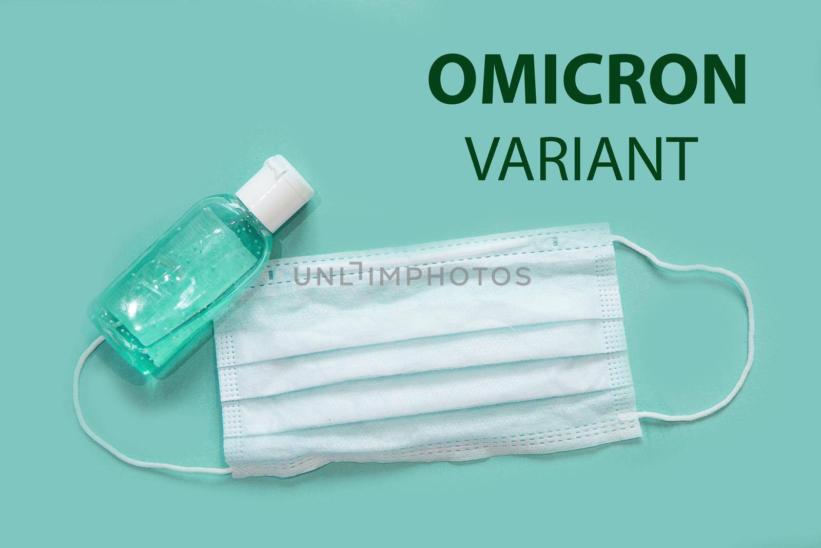 Medical mask and antiseptic on a white background with B.1.1.529 omicron variant text . A new variant of the coronavirus was discovered in South Africa in November 2021