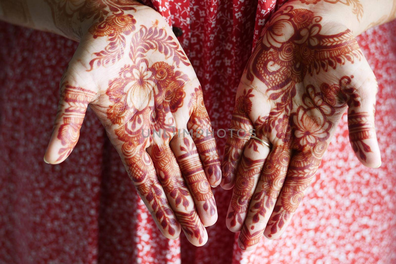 women applying henna on hand .