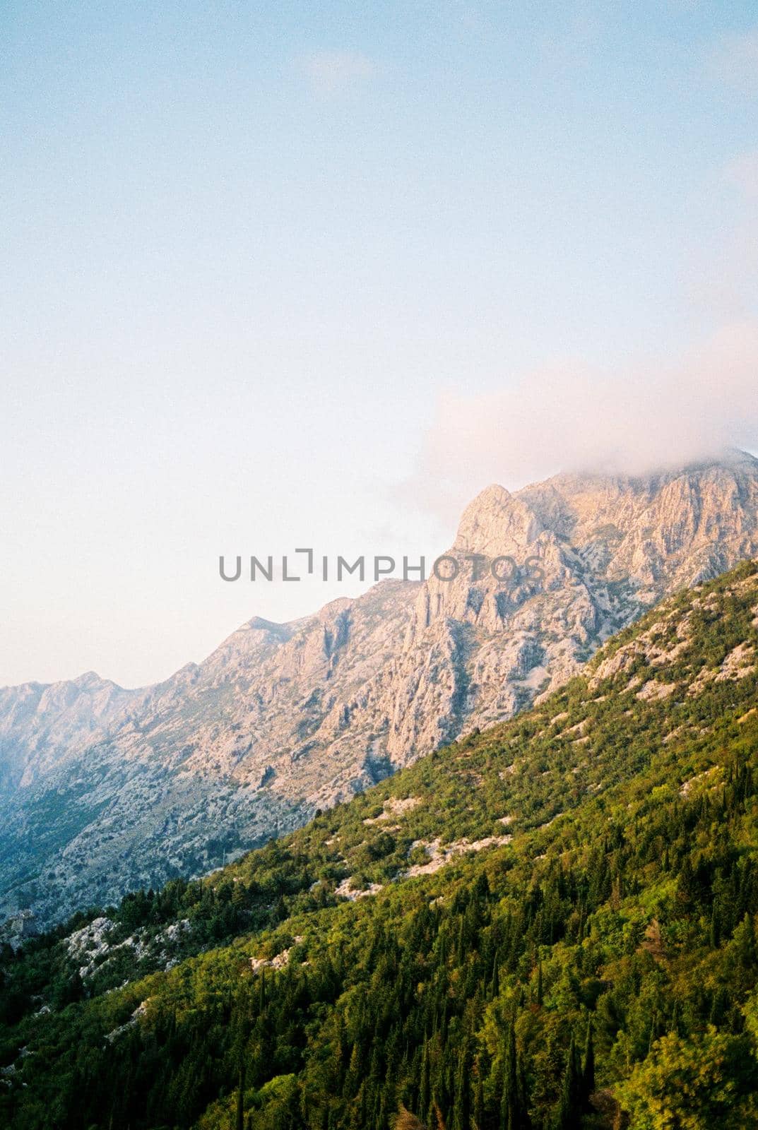 Green rocky mountains against the blue sky. High quality photo