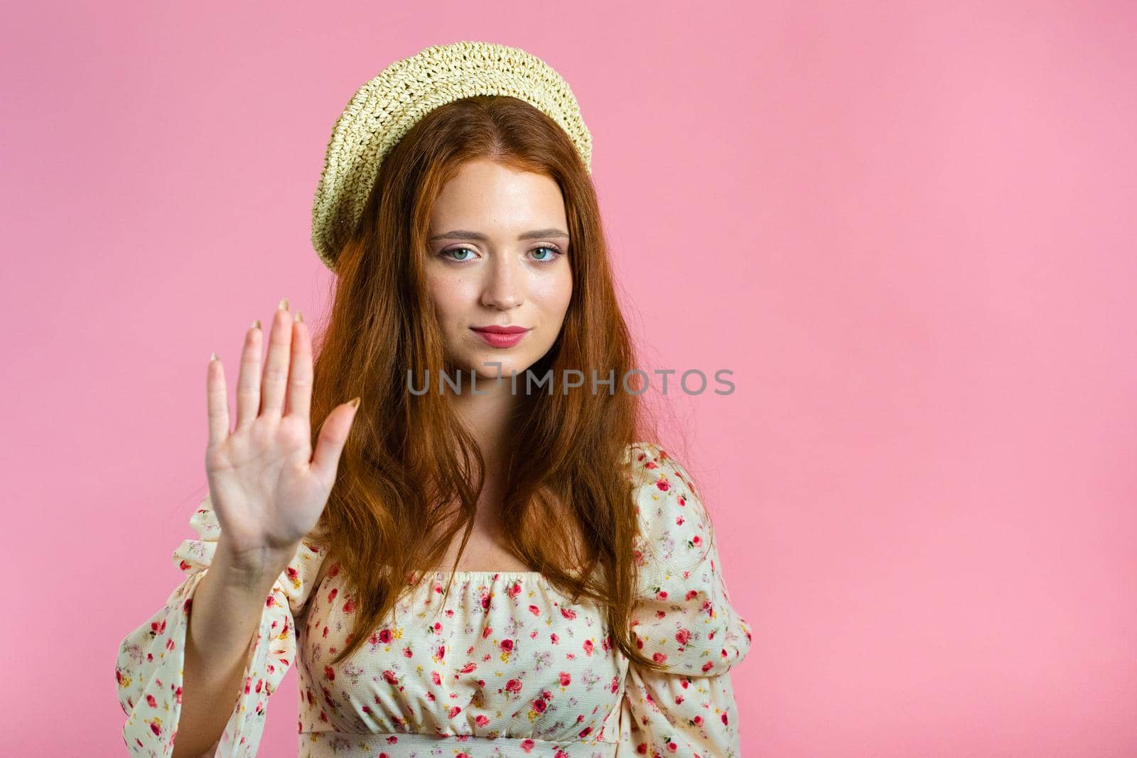 Trendy woman disapproving with NO hand sign gesture. Denying, rejecting, disagree, portrait of beautiful girl or student on pink background