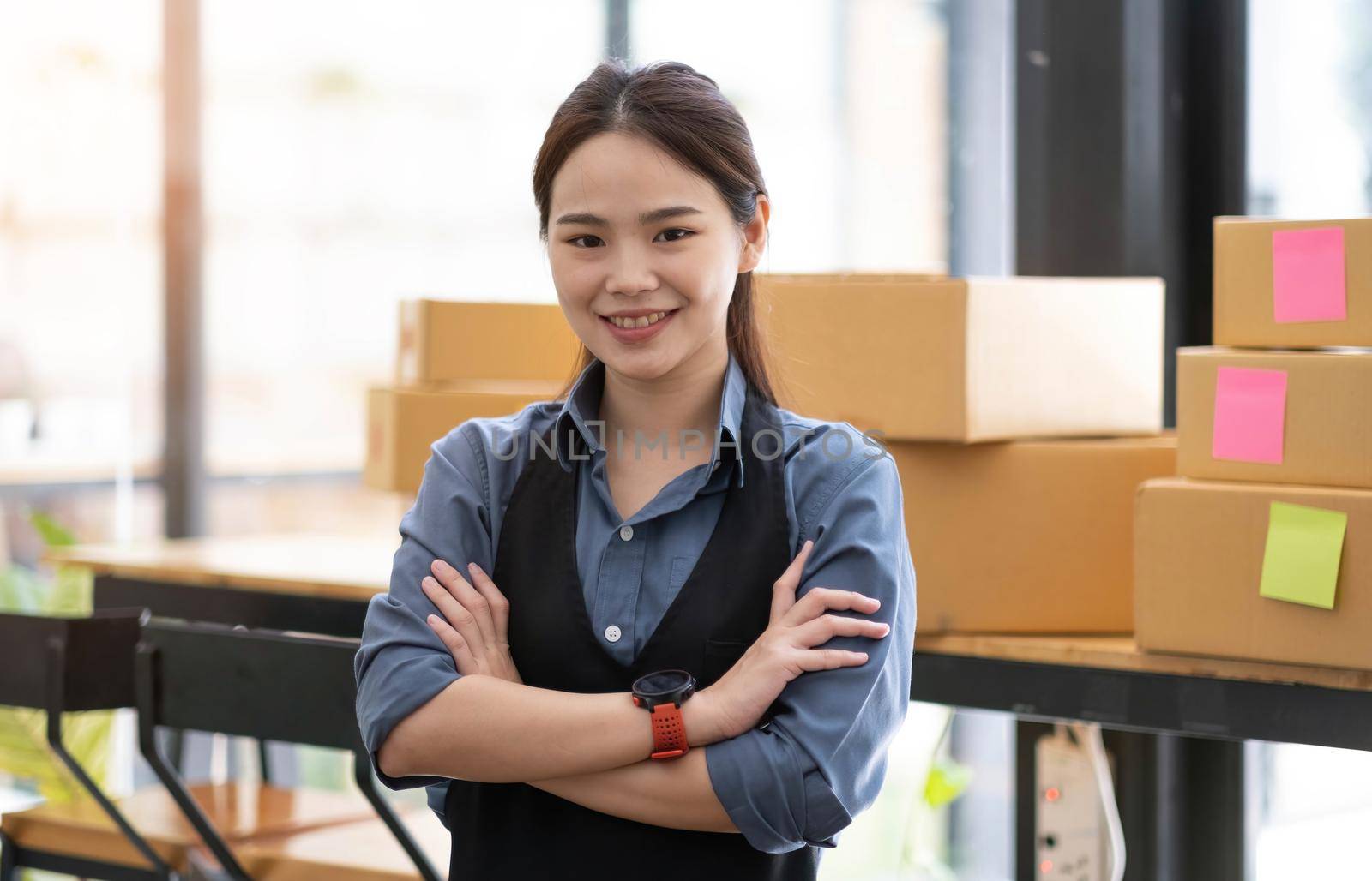 Portrait of Asian young woman SME working with a box at home the workplace.start-up small business owner, small business entrepreneur SME or freelance business online and delivery concept..