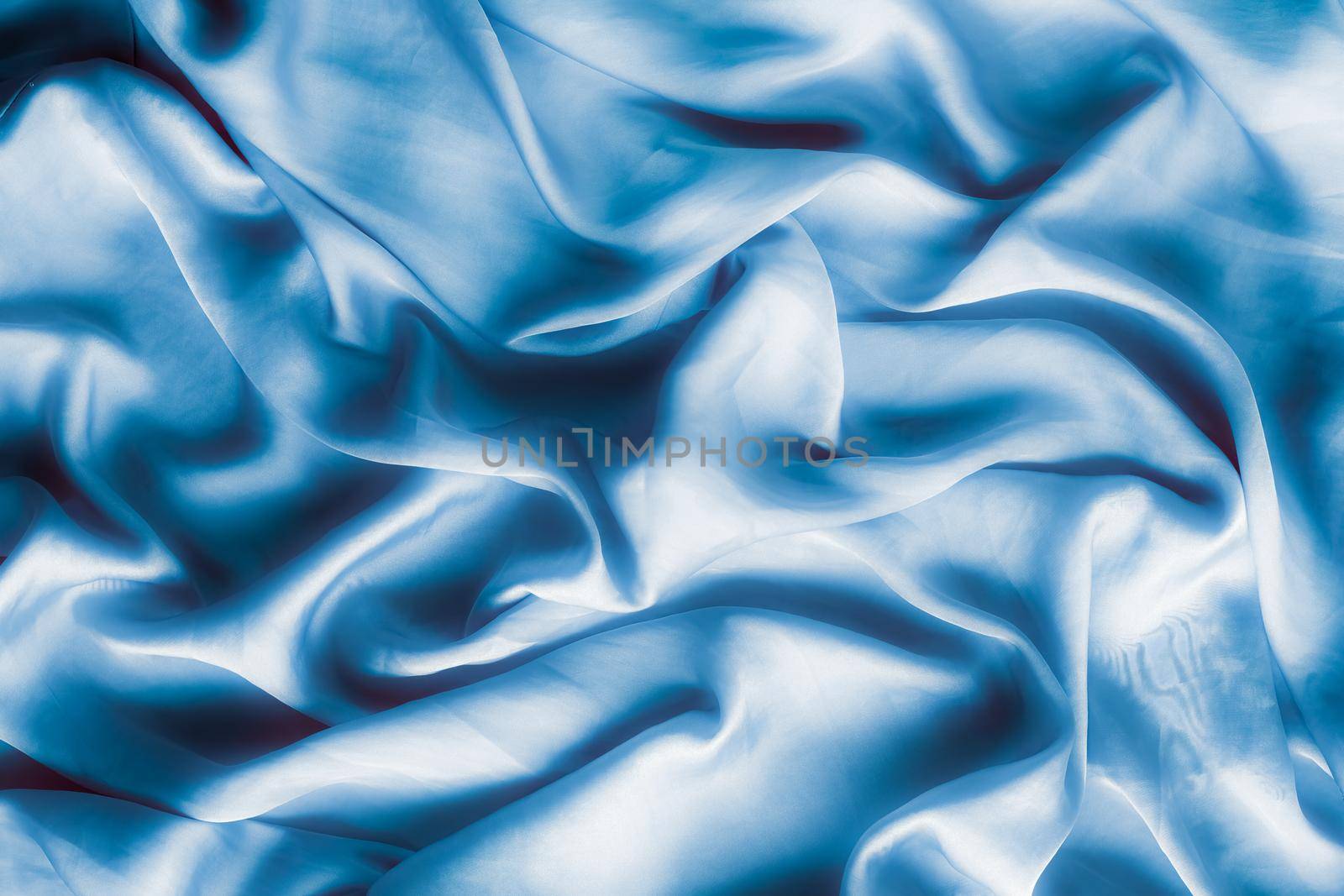 Blue soft silk waves, flatlay - elegant fabric textures, abstract backgrounds and modern pastel colours concept. Feel the touch of luxury