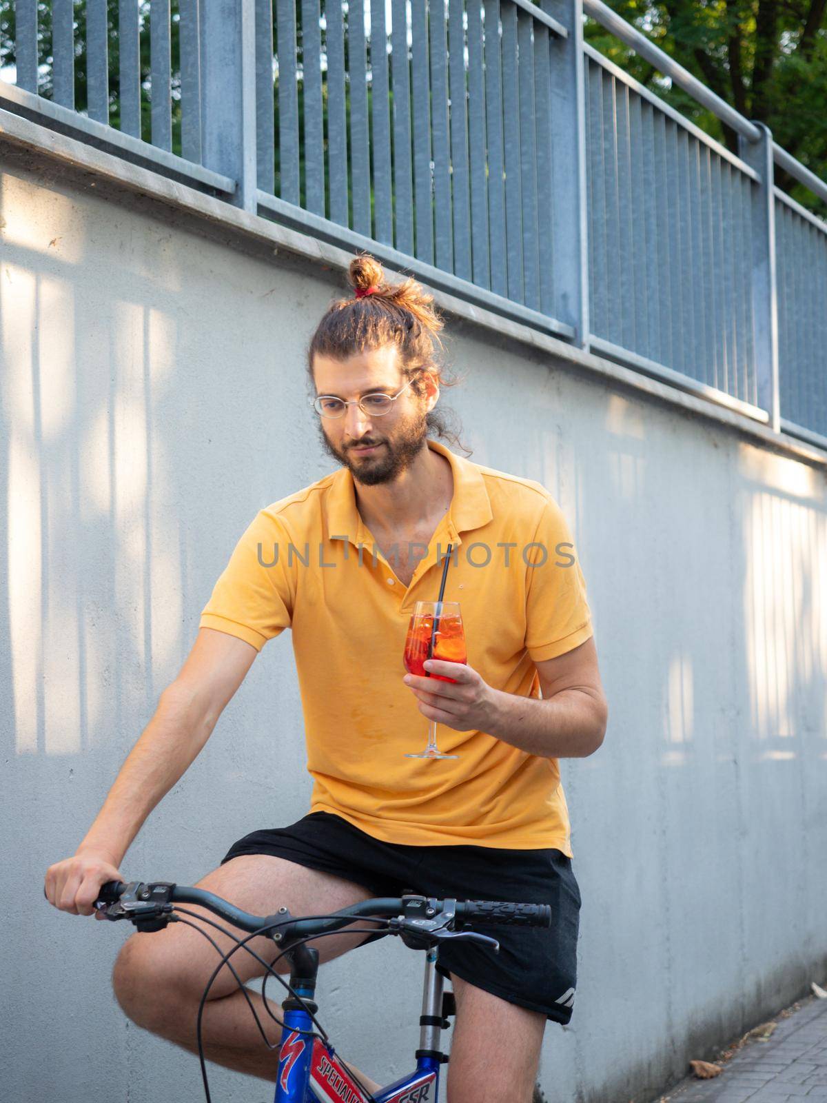 female model riding bike and holding a cocktail
