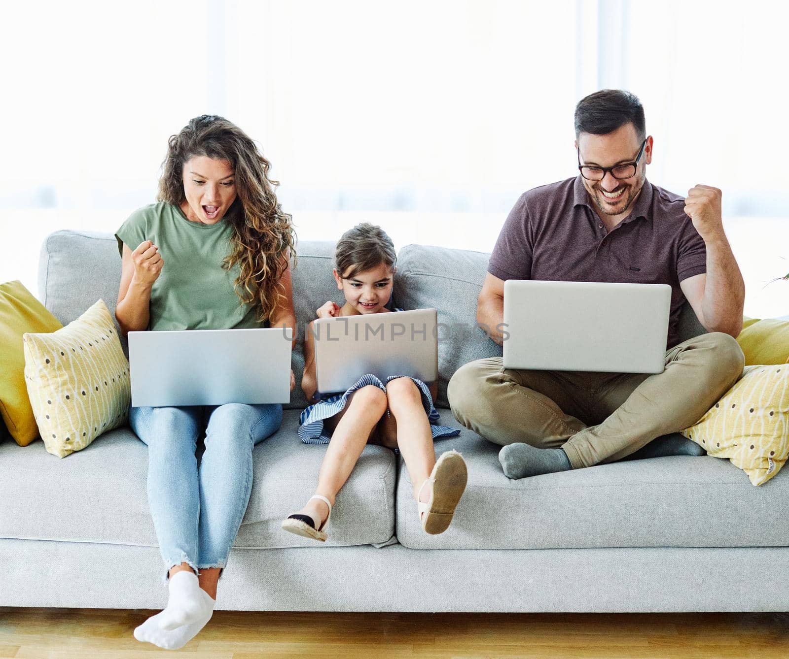 child laptop family computer woman mother father happy home man technology daughter together internet by Picsfive