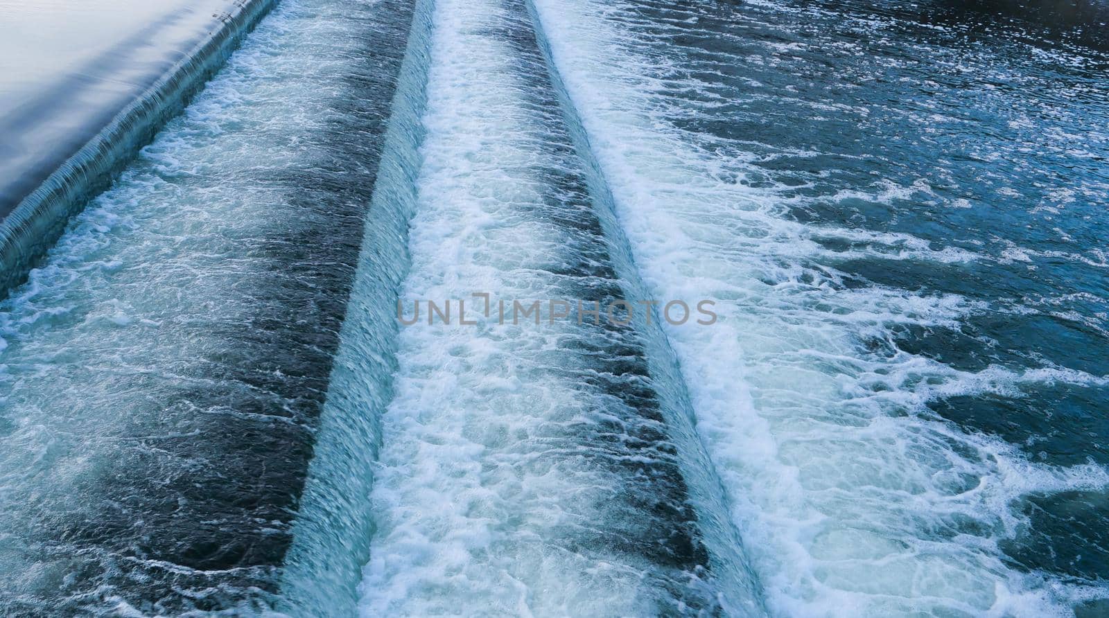 Water flowing quickly through a rapid cascade of River.