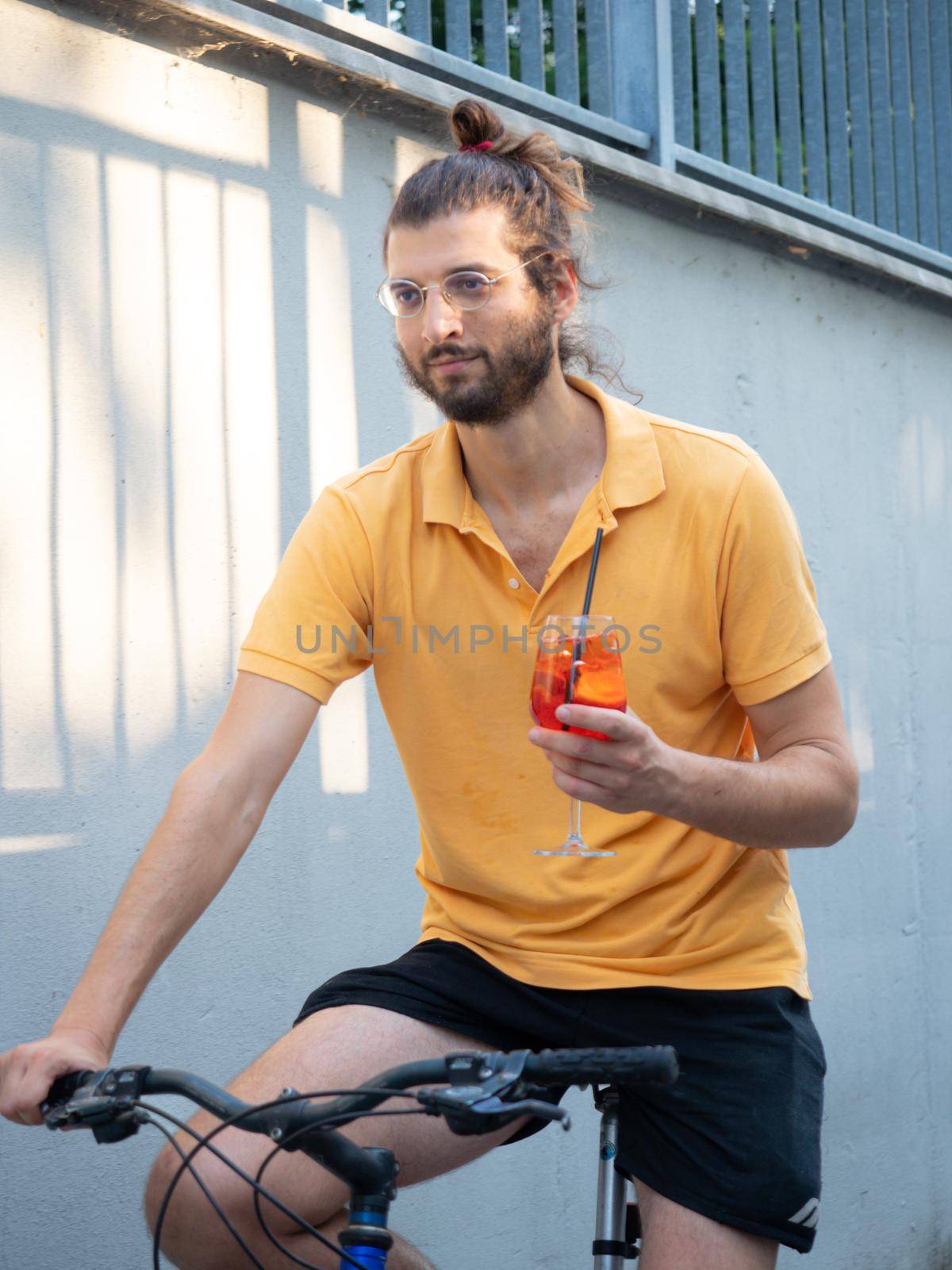 female model riding bike and holding a cocktail