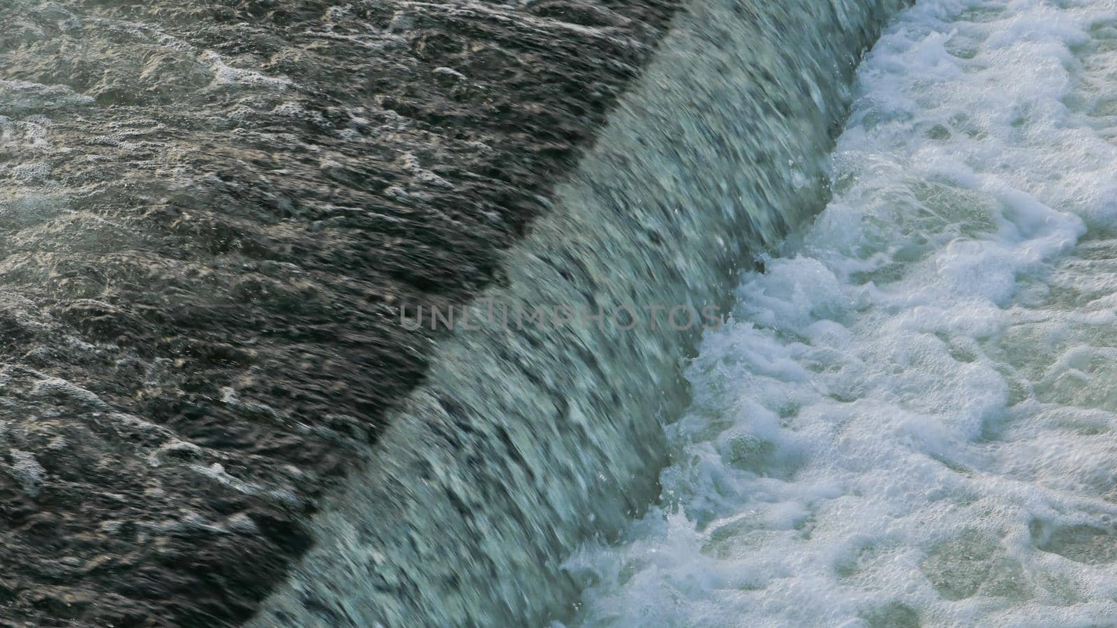 Close-up view of the water dam on the river. by gelog67