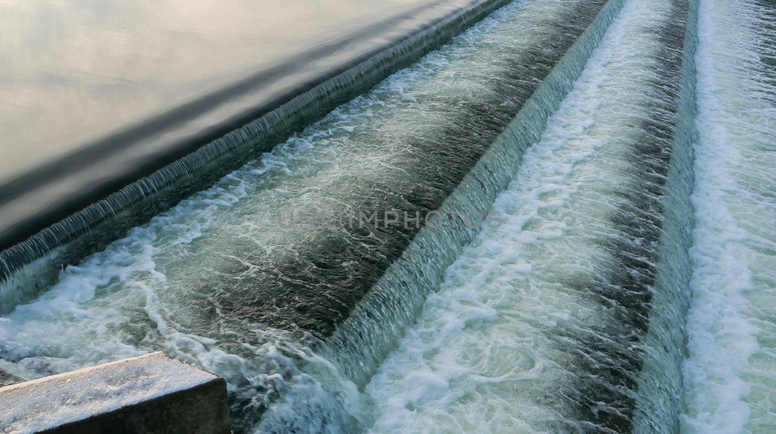 Cascade of falling water on the reservoir. High quality photo