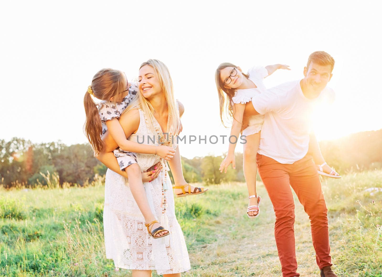 Portrait of a young happy family having fun outdoors