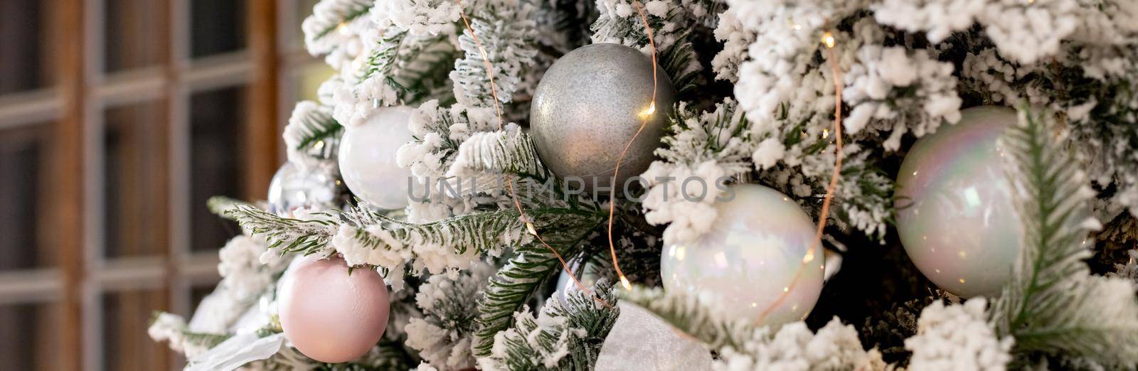 Christmas texture of white delicate Christmas tree and Christmas decorations, balls and ribbons, garland and lights.