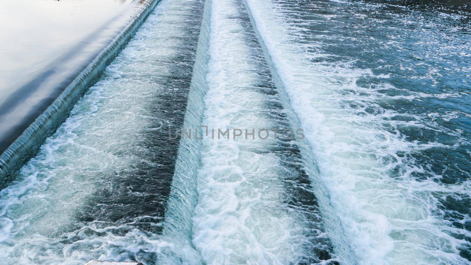 The flow of water from the lake through the dam.