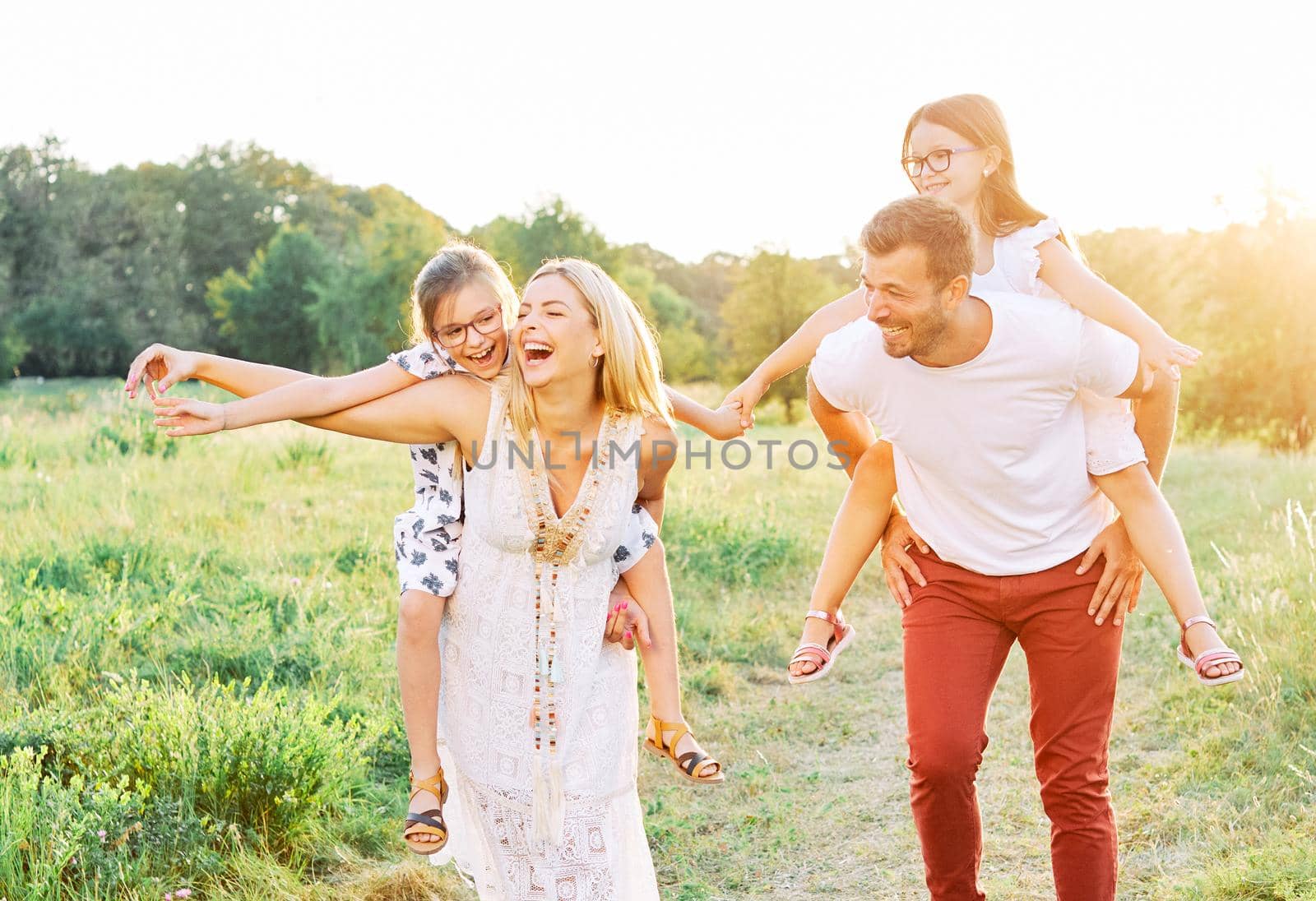 child family outdoor mother woman father girl happy happiness lifestyle having fun bonding piggyback by Picsfive