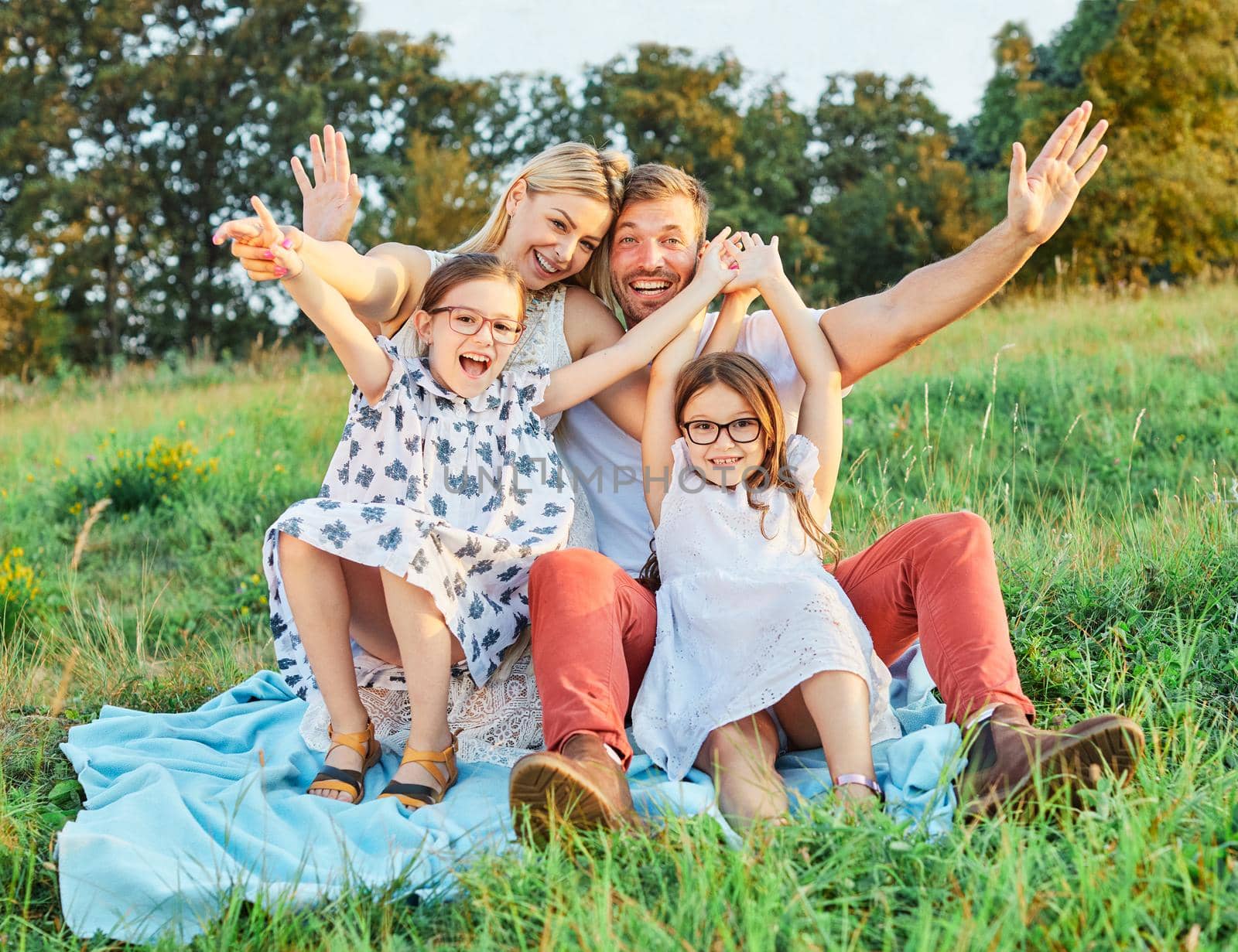 Portrait of a young happy family having fun outdoors