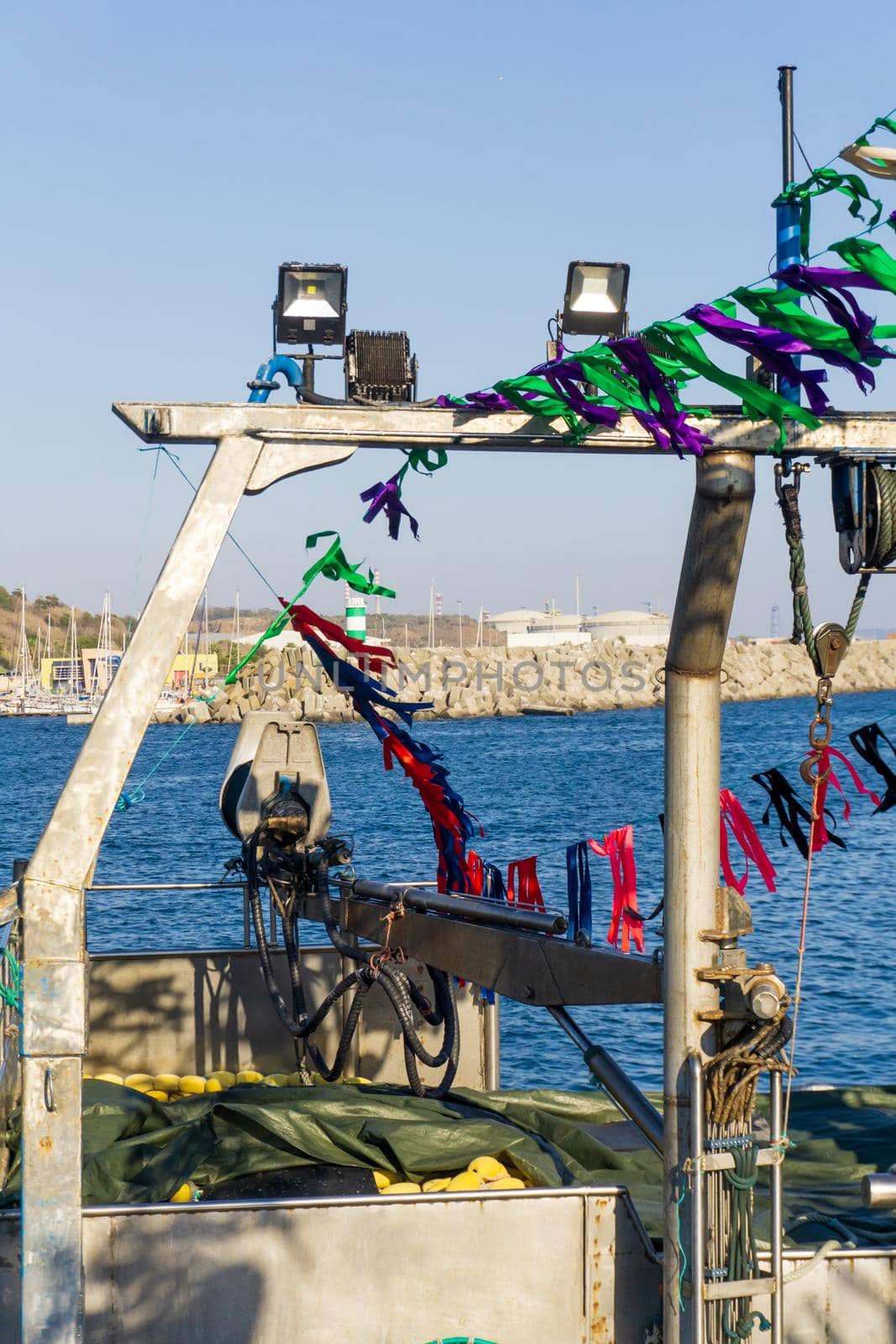 Fishing boat decorated with colorful ribbons close up