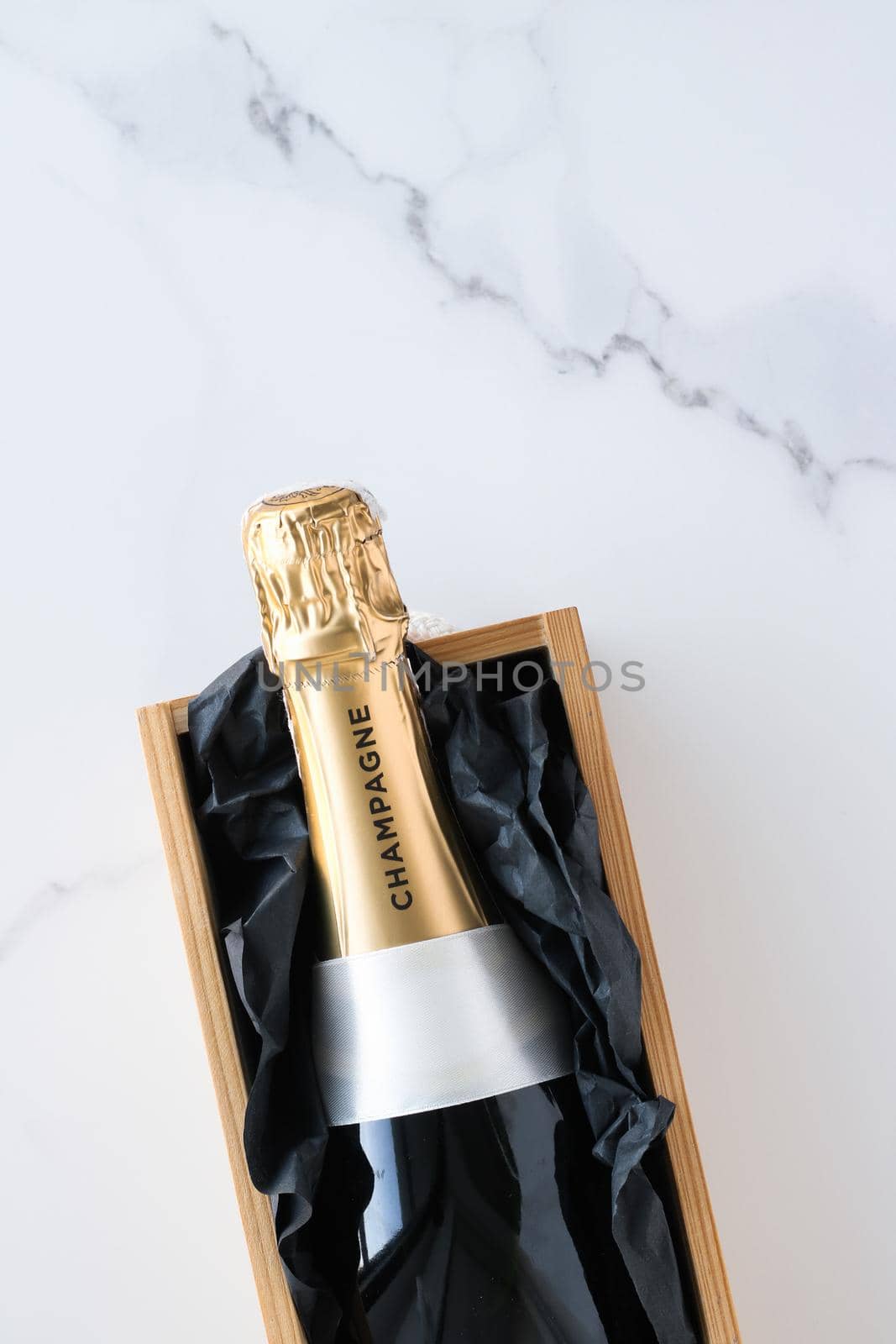 Wedding celebration, lifestyle and luxury present concept - A champagne bottle and a gift box on marble