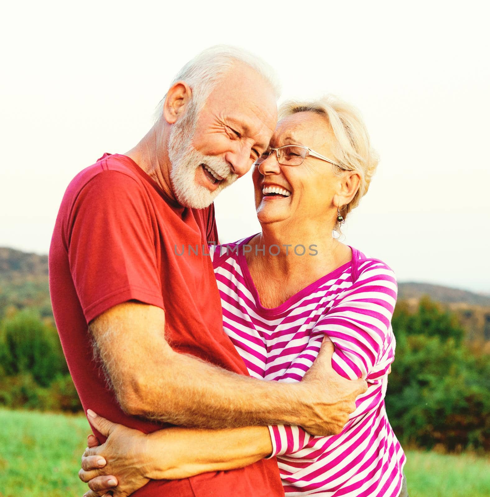 woman man outdoor senior couple happy lifestyle retirement together smiling love hug nature mature by Picsfive