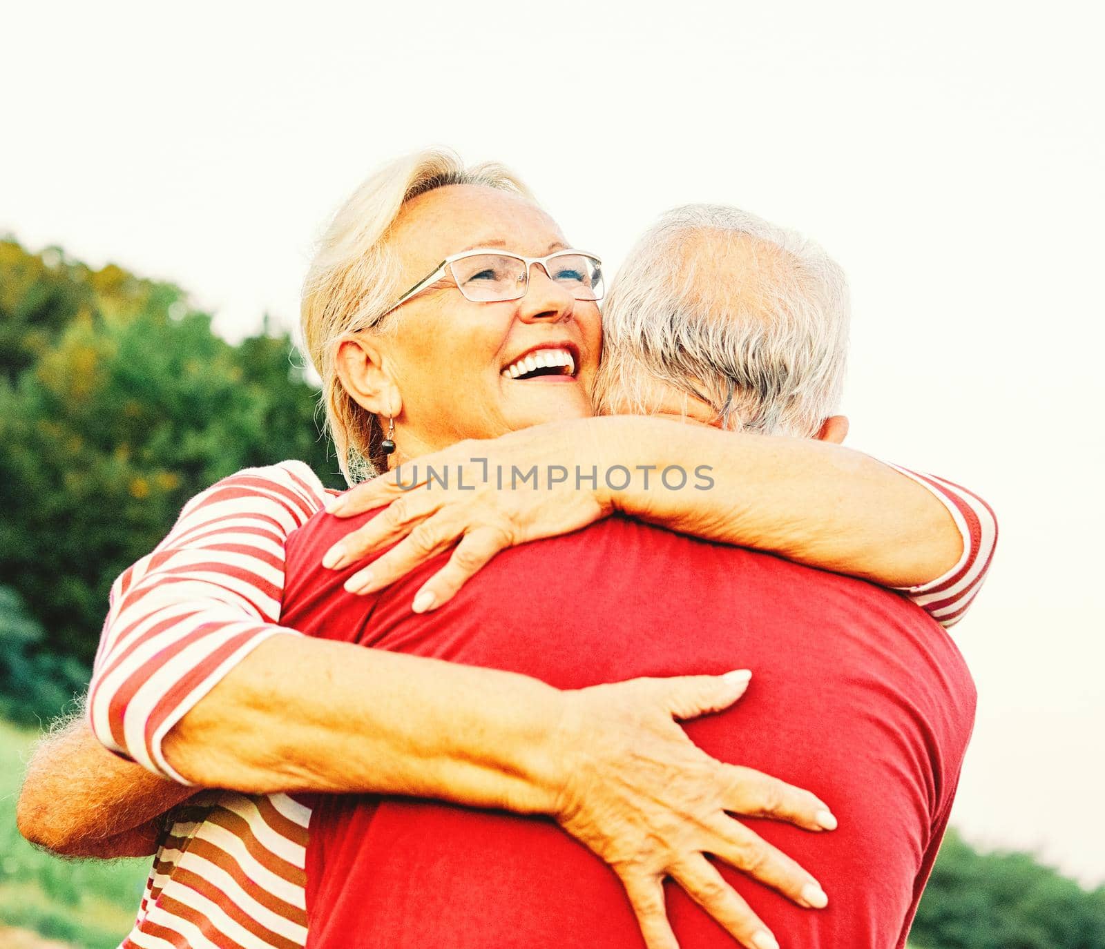 woman man outdoor senior couple happy lifestyle retirement together smiling love hug nature mature by Picsfive