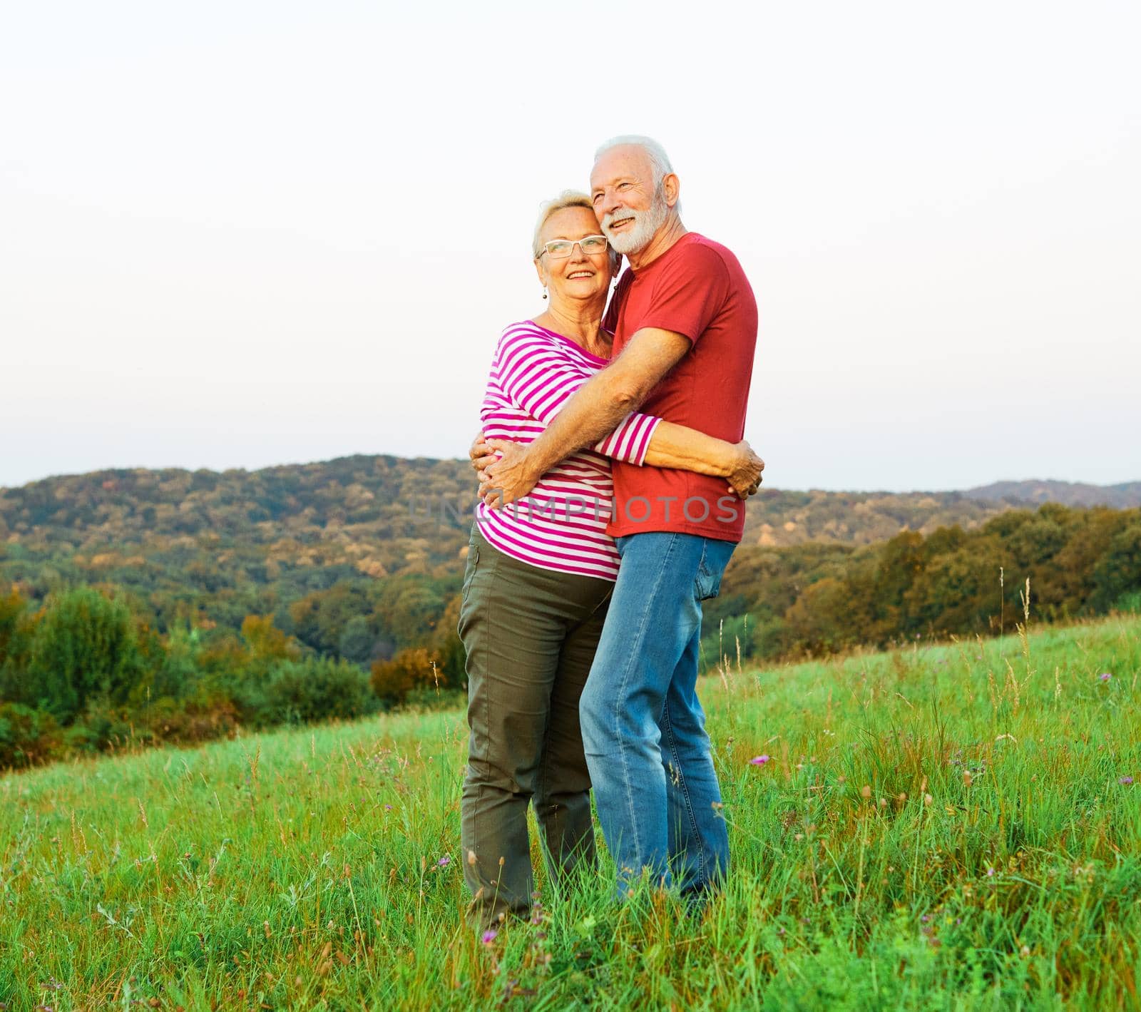 woman man outdoor senior couple happy lifestyle retirement together smiling love hug nature mature by Picsfive