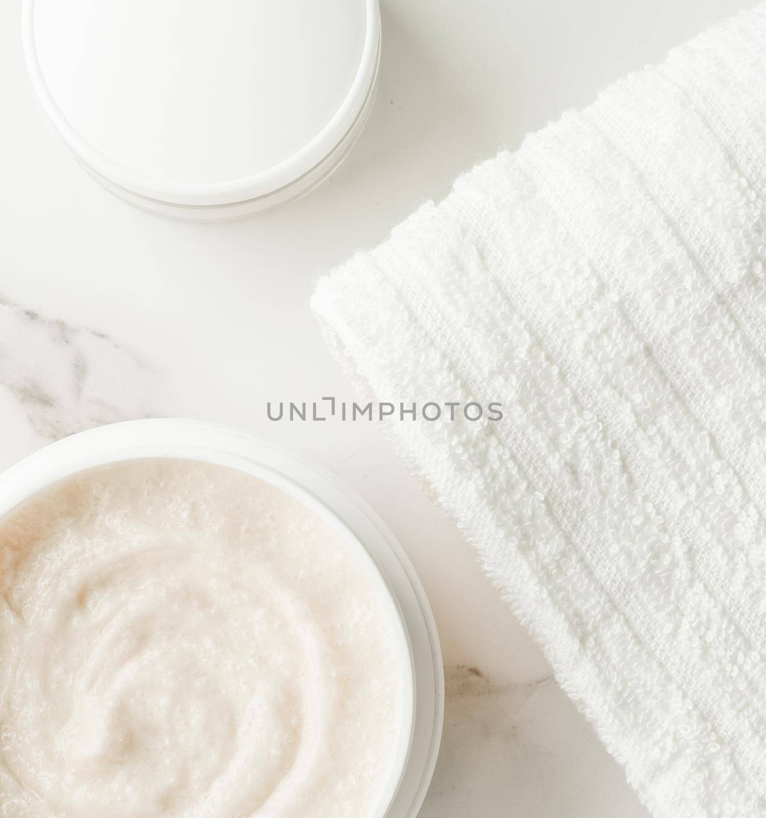 Scrub and exfoliating cream products on a marble, flatlay - skincare and body care, luxury spa and clean cosmetic concept. Health and beauty of your skin