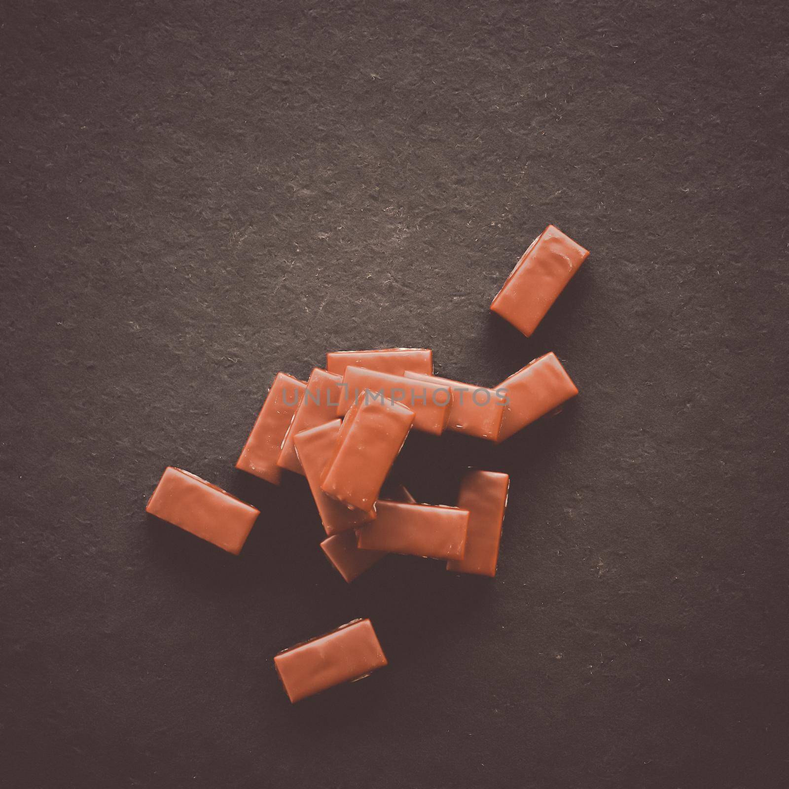 Sweet swiss chocolate candies on a stone tabletop, flatlay - desserts, confectionery and gluten-free organic food concept. All you need is chocolate