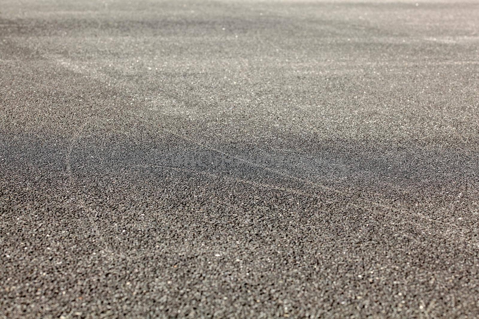 Detail of asphalt road from low angle. Abstract urban background.