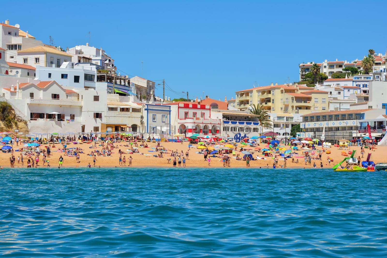 PORTIMAO, PORTUGAL - AUGUST 02, 2017: Overcrowded beach in the south of the Portuguese region of the Algarve