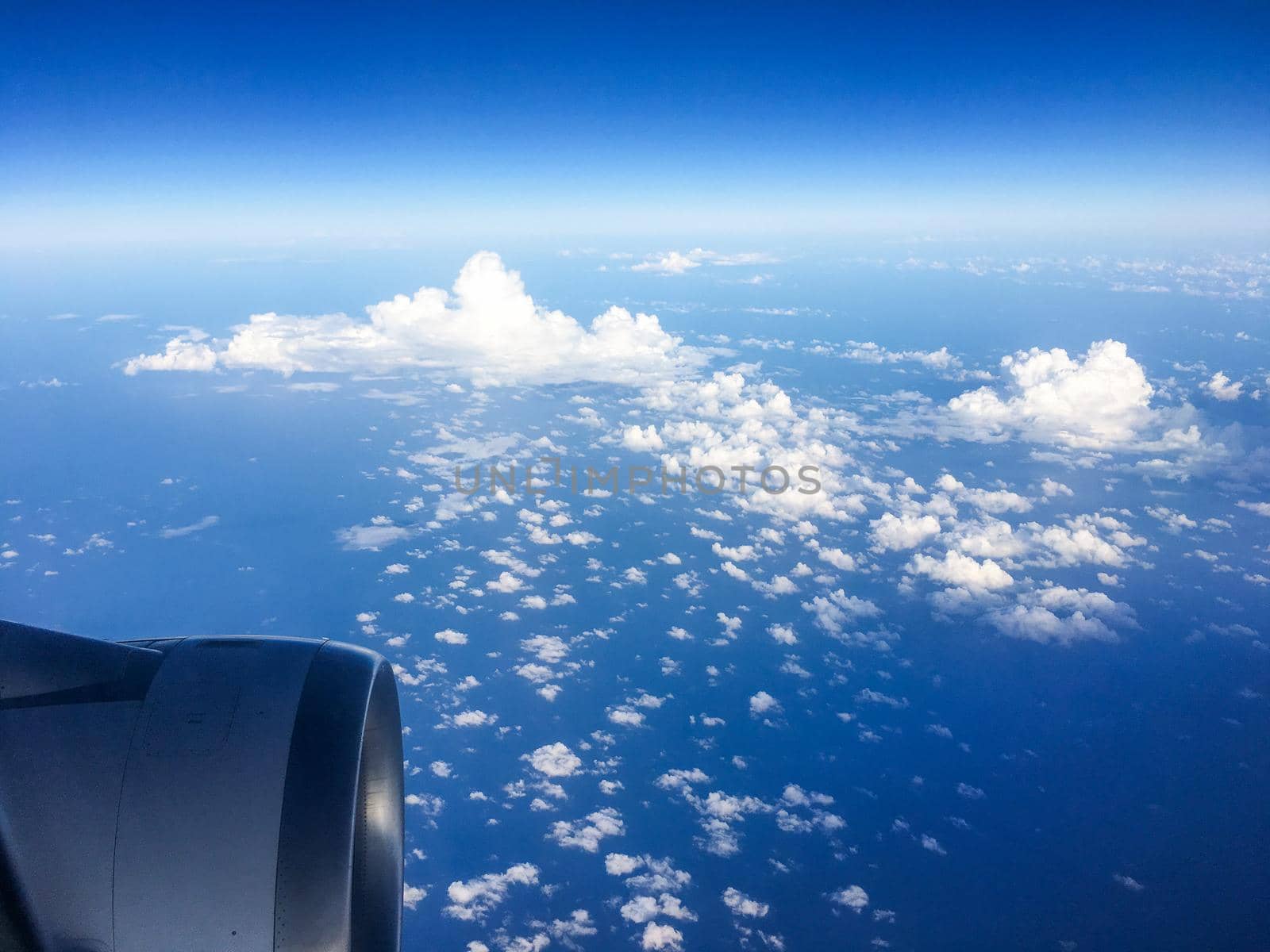 Travel, cloudscape and natural environment concept - View from the airplane window, sky and ocean blue