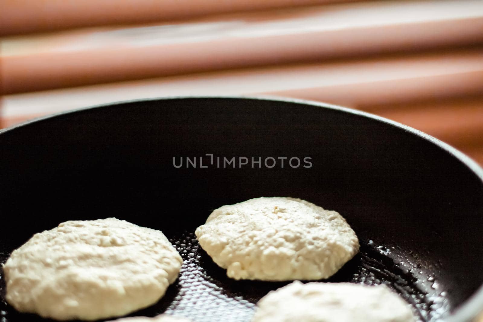 Pancakes on frying pan, rustic cookbook recipe - weekend cooking, food blog and homemade cuisine concept. Making your favorite pancakes