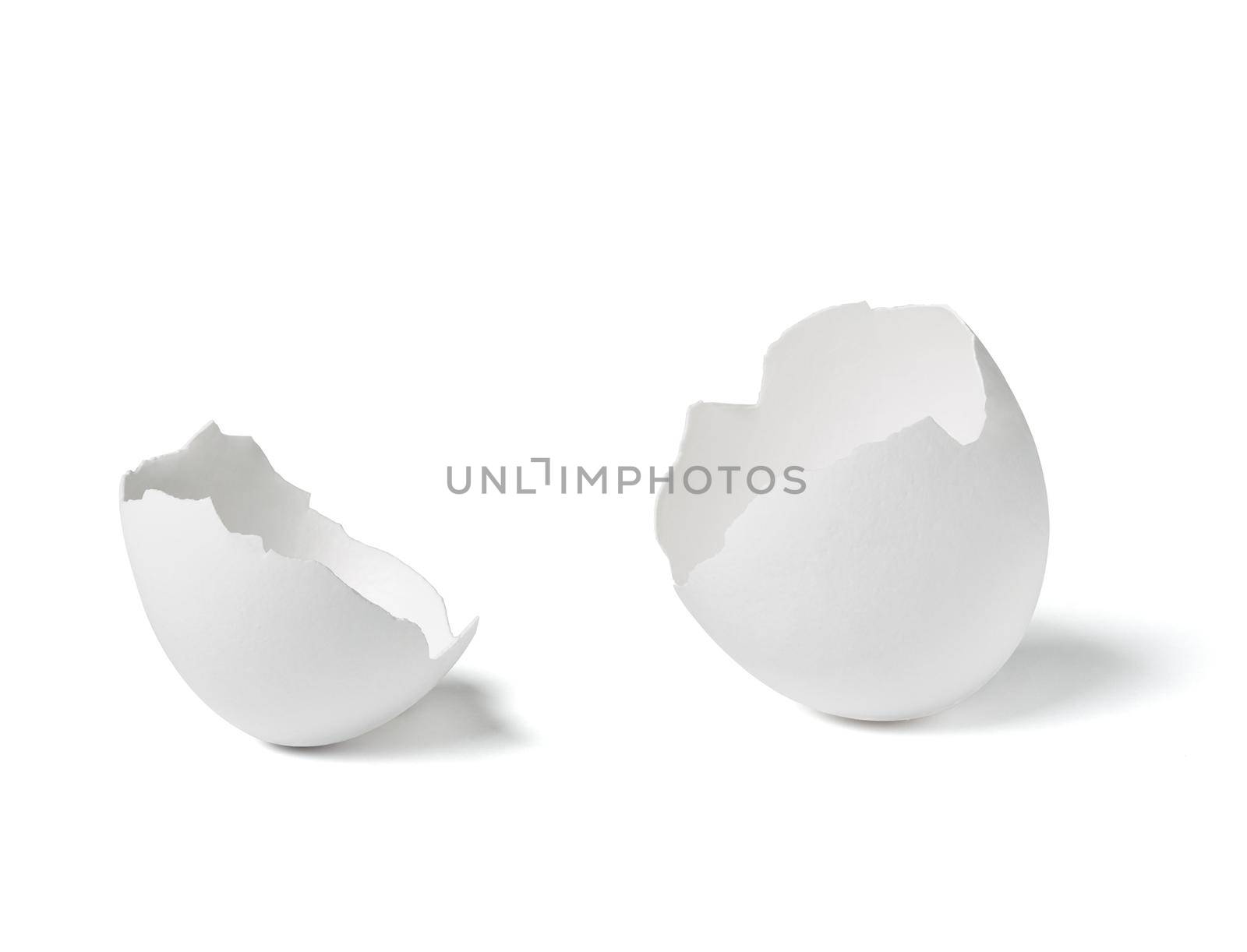 Close up of a broken white eggshell on white background