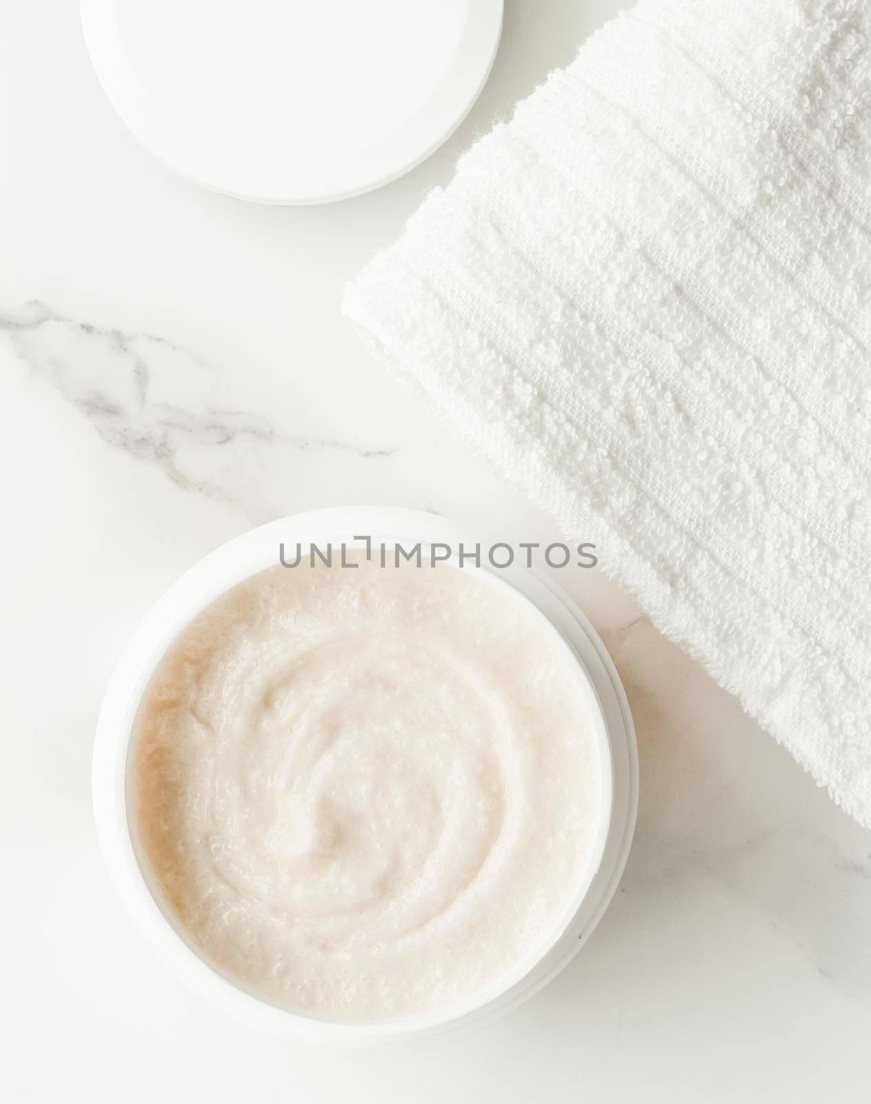 Scrub and exfoliating cream products on a marble, flatlay - skincare and body care, luxury spa and clean cosmetic concept. Health and beauty of your skin