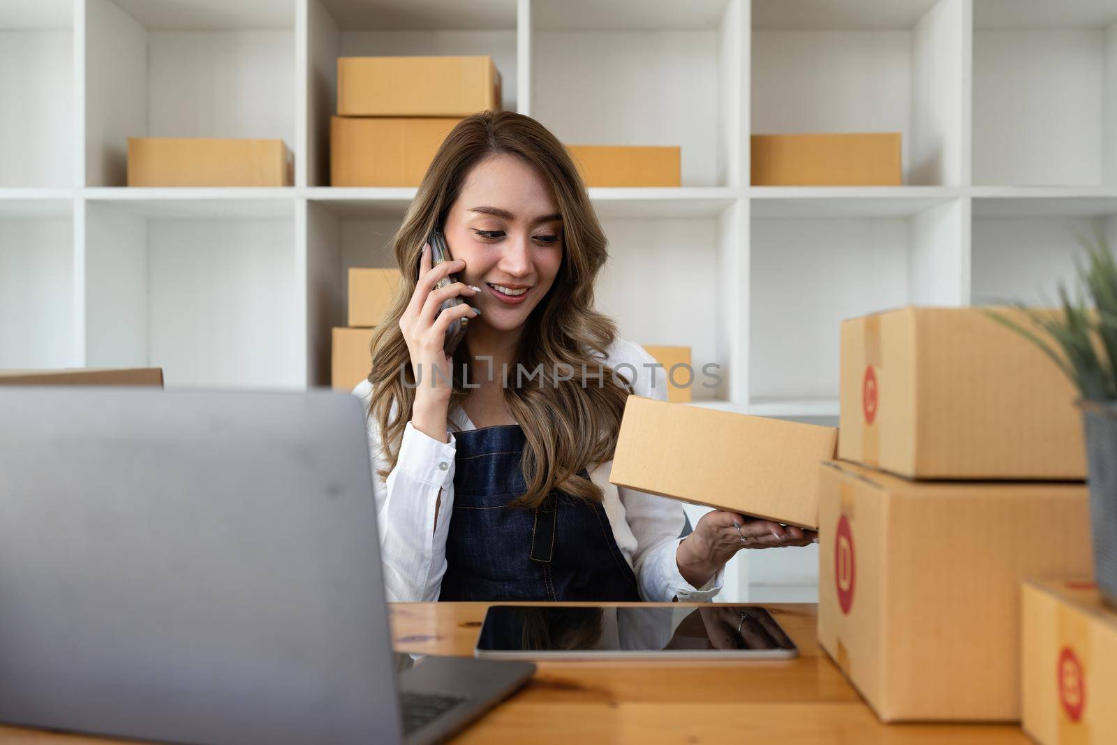 Attractive Asian SME business woman working at home office. online shopping concept.