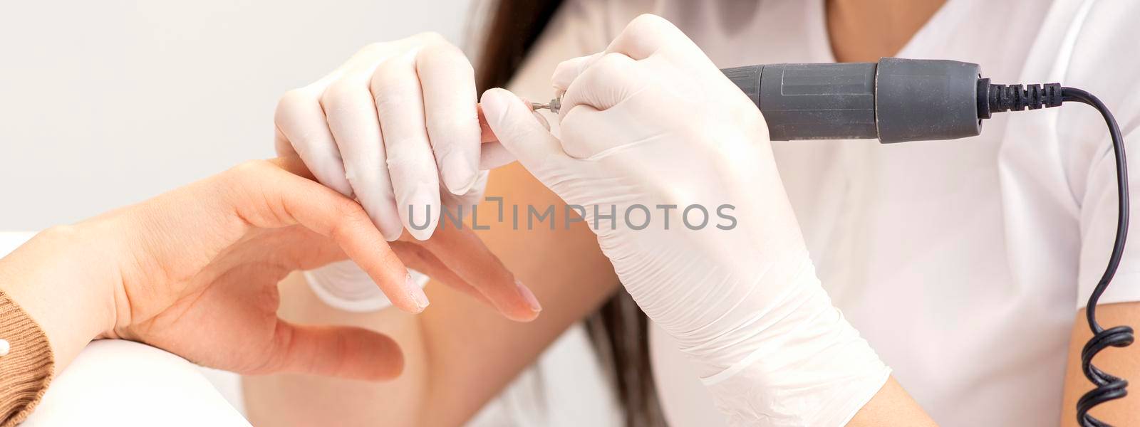Manicure master removes nail polish by okskukuruza