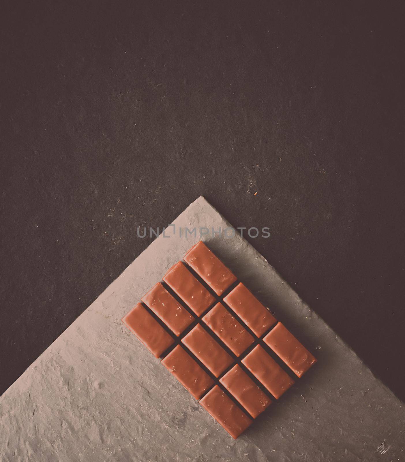 Sweet swiss chocolate candies on a stone tabletop, flatlay - desserts, confectionery and gluten-free organic food concept. All you need is chocolate
