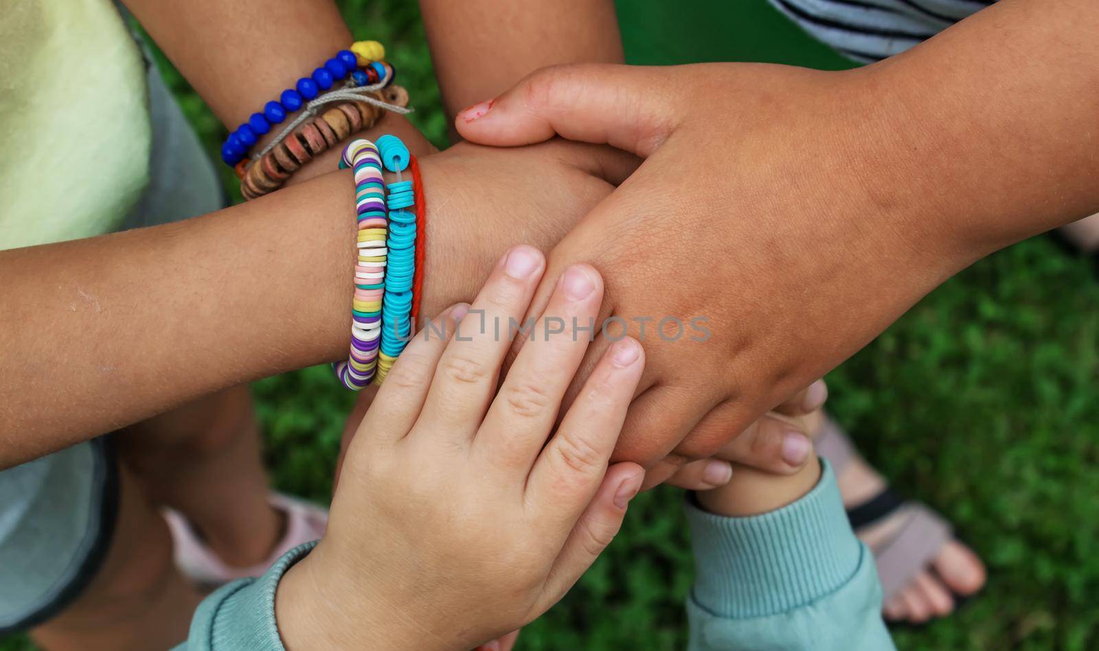 The children put their hands together. Selective focus. kids