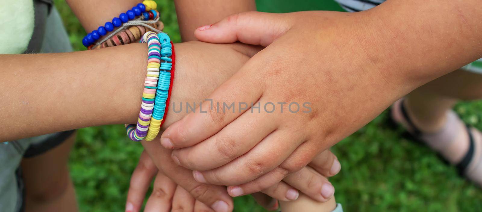 The children put their hands together. Selective focus. kids