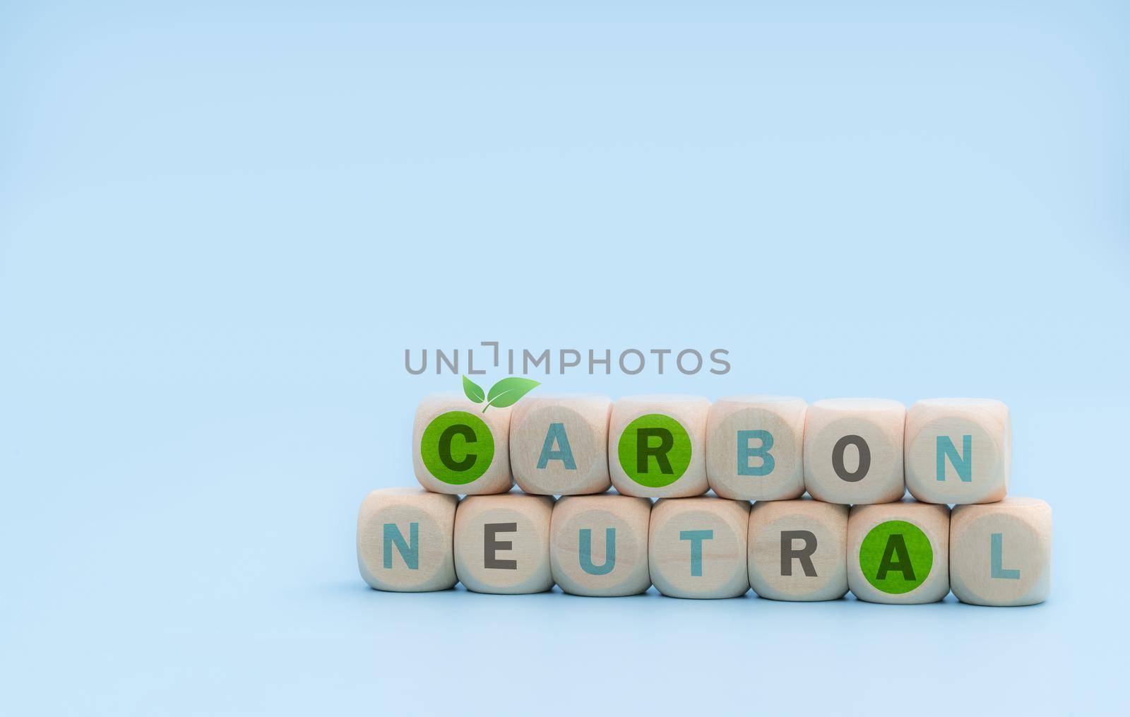 Carbon neutral concept. Wooden cubes with carbon neutral words on blue background. CO2 neutral web banner. Carbon neutral corporate business long term strategy. Global carbon neutrality concept. 