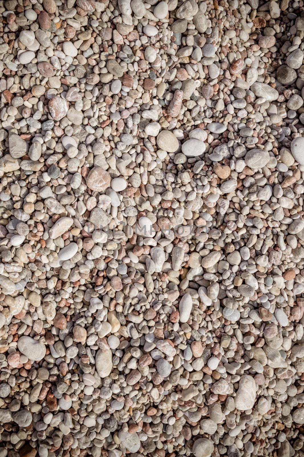 Pebble stone background.Small colorful pebbles background, simplicity, daylight stones