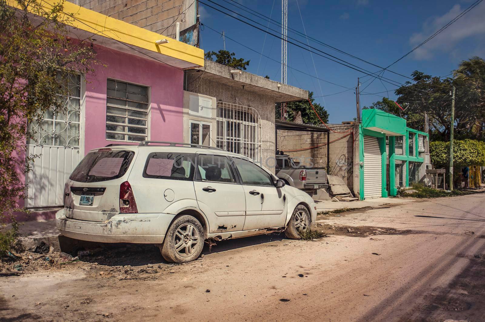 Tulum, Mexico 20 august 2022: View of a car destroyed and corroded by wear and tear on the side of a street in a poorer neighborhood of Tulum, Mexico
