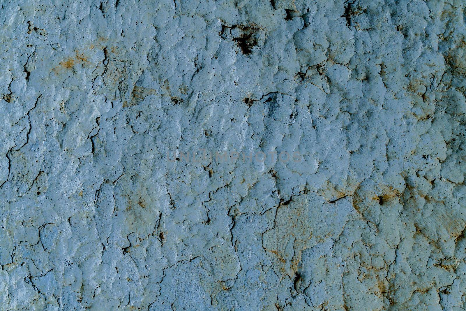 textured background of a wall chipped by the passage of time