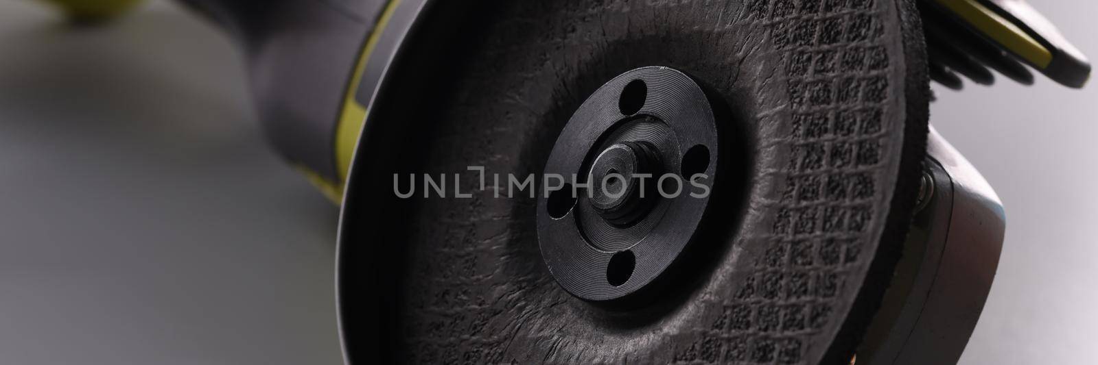 Close-up of electrical saw, grinder for metal works on grey surface. Macro of powerful circular saw equipment for construction works. Carpentry concept